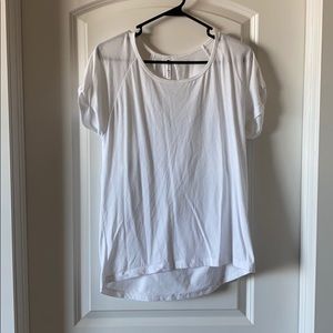 Fabletics white shirt with open shoulder.